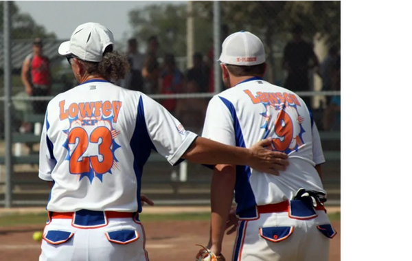 Two players on the softball field looking away